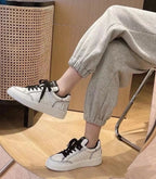 Chanel Low-top Sneakers Off-White Leather Black Laces
